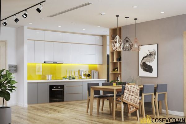 Thiết kế phòng bếp trong căn hộ 70m2 nối liền phòng khách không sử dụng vách ngăn cách thay vào đó là sự khéo léo phân chia không gian